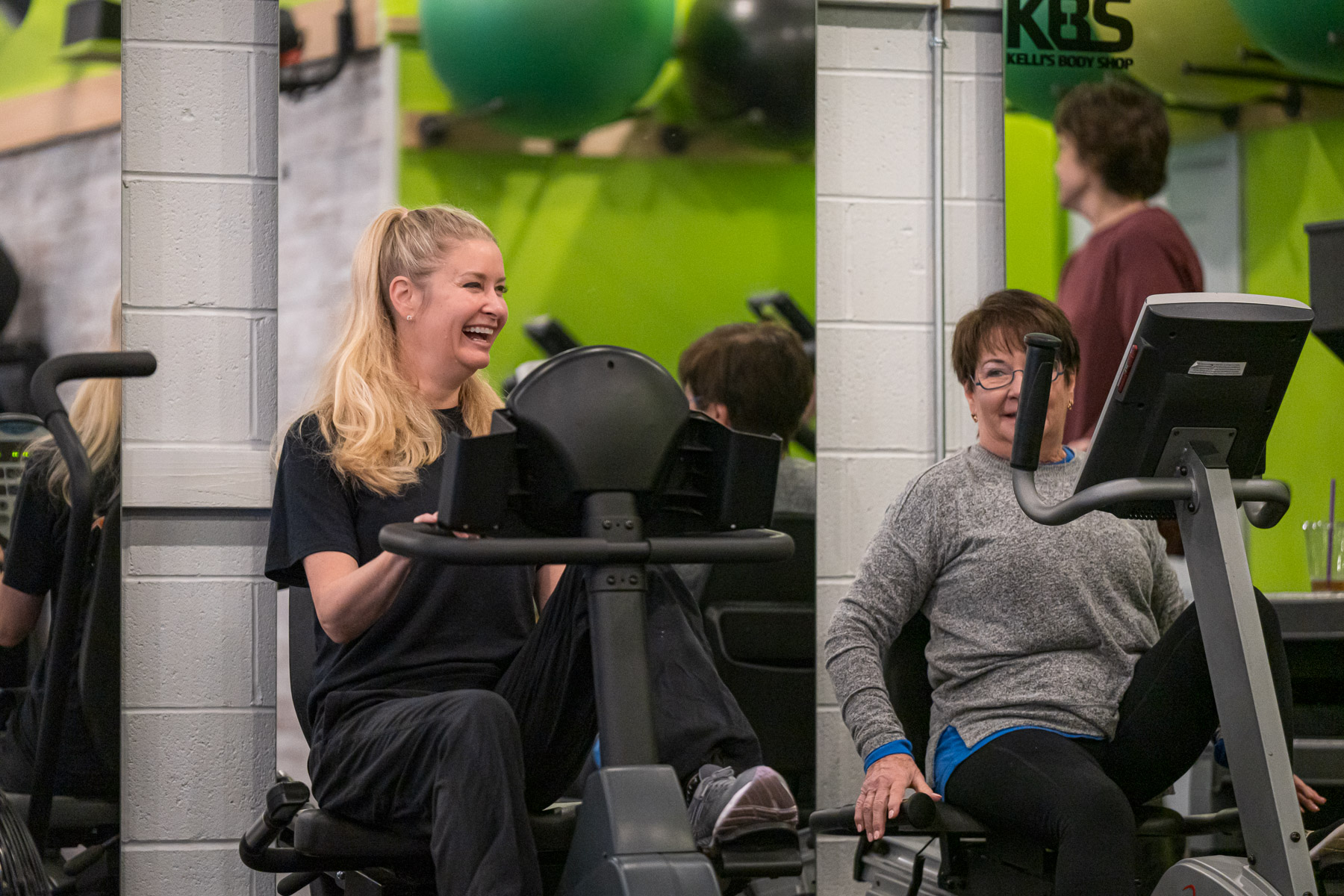 Two women laughing while working out